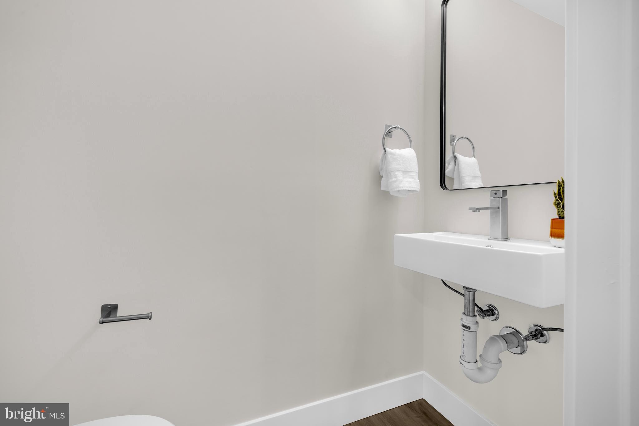 3827 Cottage Avenue Baltimore, MD 21215 - Photo 28 of 43 a bathroom with a sink and mirror