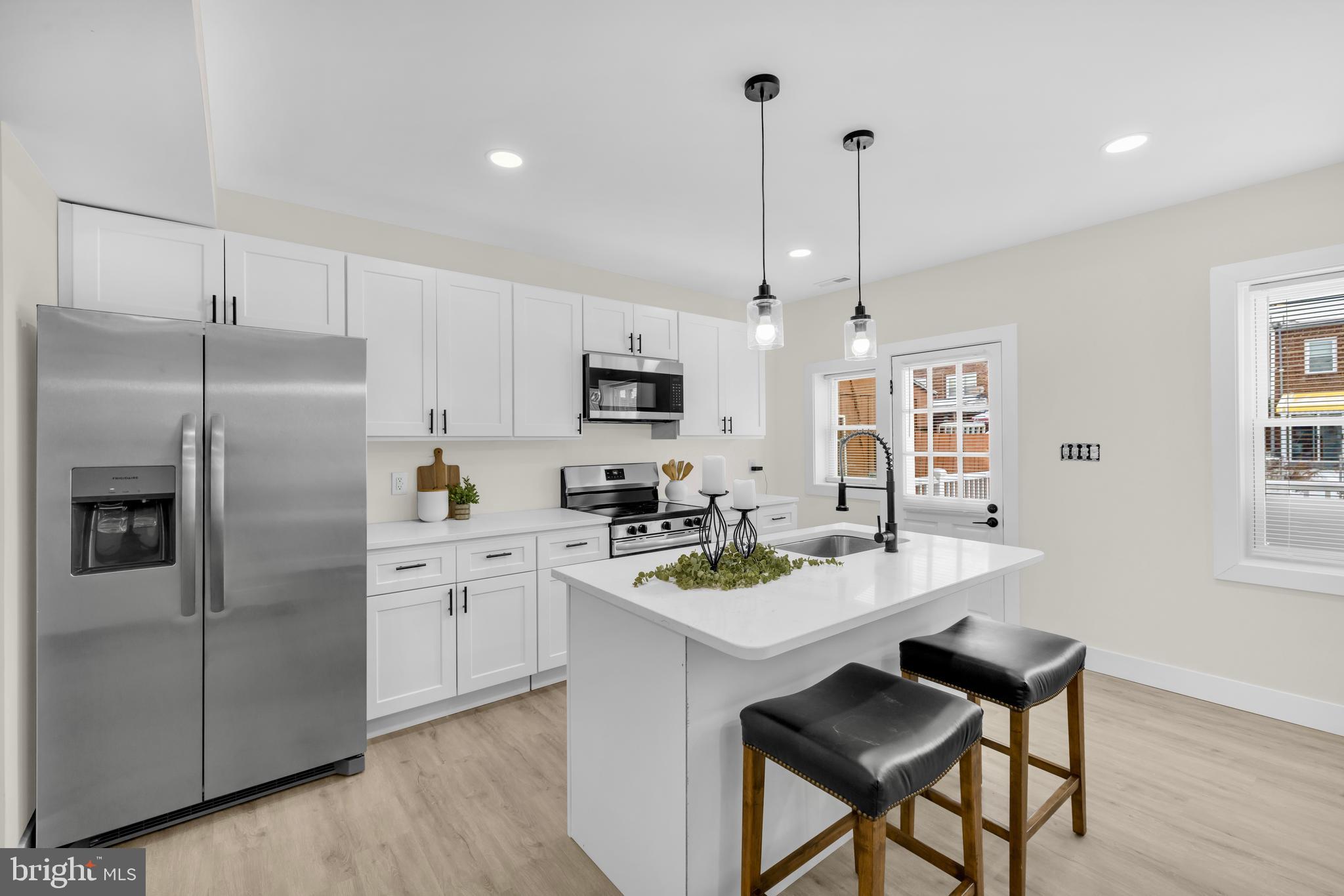 3827 Cottage Avenue Baltimore, MD 21215 - Photo 3 of 43 a kitchen that has a lot of cabinets a sink and appliances in it