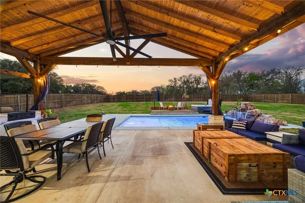a view of a patio with a table chairs and a backyard