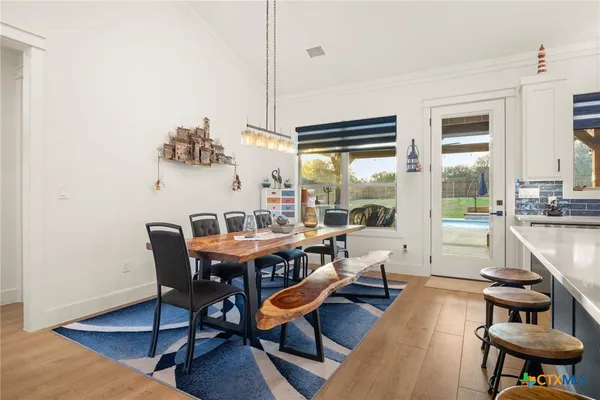 a view of a dining room with furniture wooden floor and a chandelier