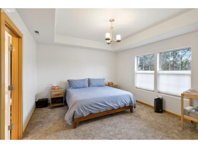 a bedroom with a bed and a view of kitchen