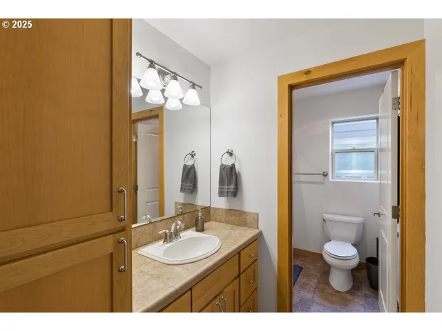 a bathroom with a toilet sink and mirror