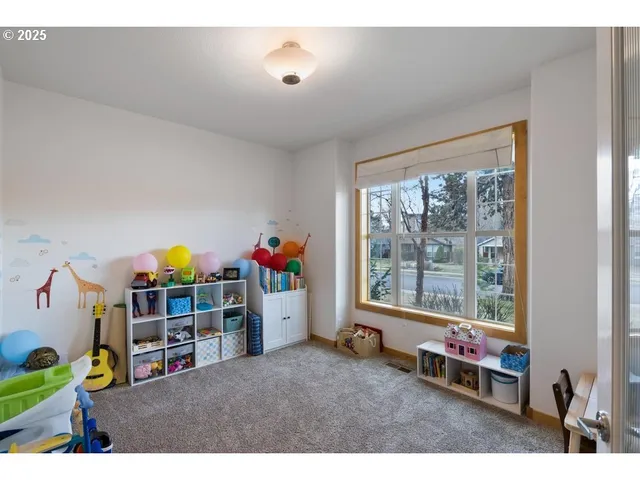 a living room with lots of furniture and a large window