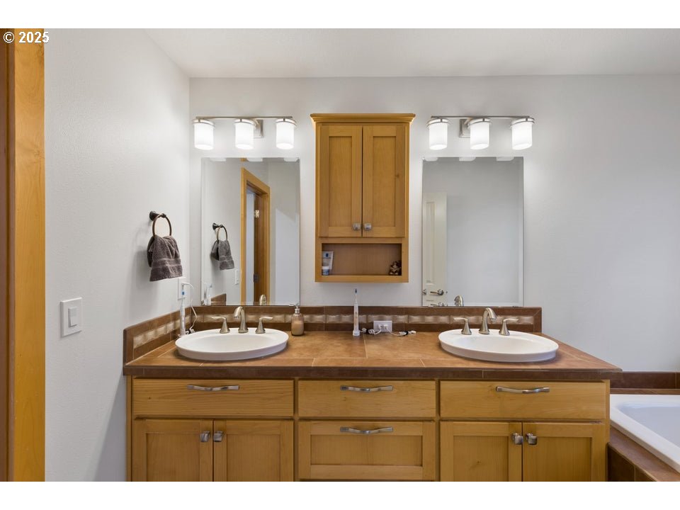 109 Southwest Taft Avenue Bend, OR 97702 - Photo 5 of 23 a bathroom with a sink and a mirror