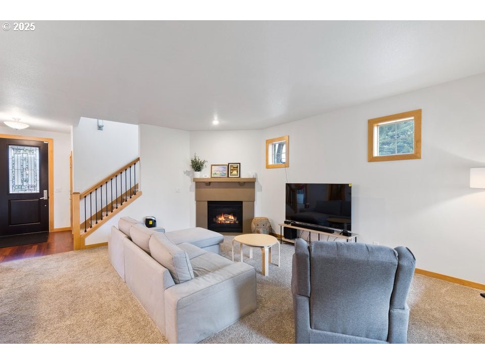 109 Southwest Taft Avenue Bend, OR 97702 - Photo 9 of 23 a living room with furniture a flat screen tv and a fireplace