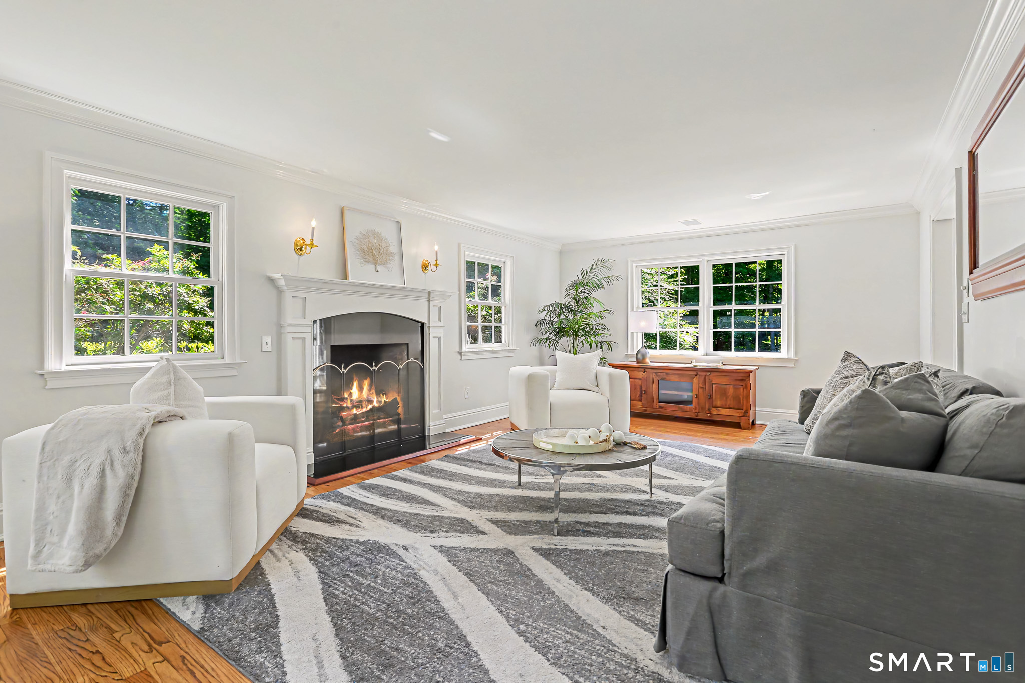 6 Adams Way Weston, CT 06883 - Photo 5 of 40 The light-filled living room has a gas fireplace.