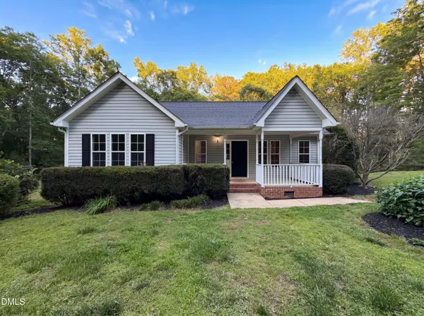 a front view of a house with a yard and porch