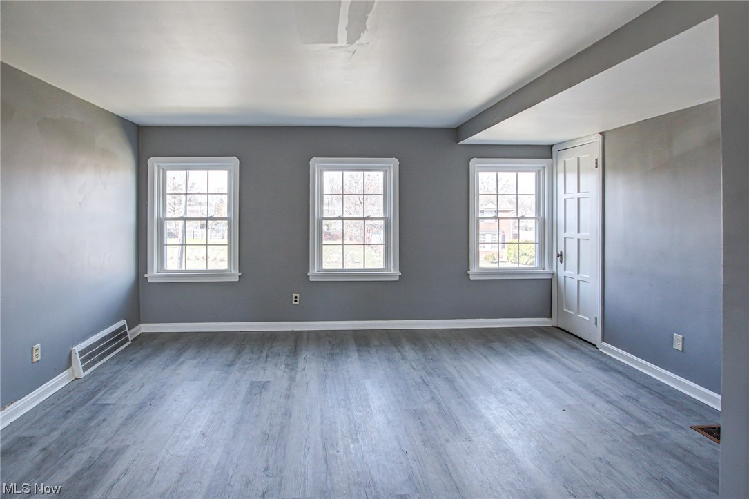 3423 Westbury Road Cleveland, OH 44120 - Photo 23 of 38 Empty room with plenty of natural light and dark hardwood / wood-style floors