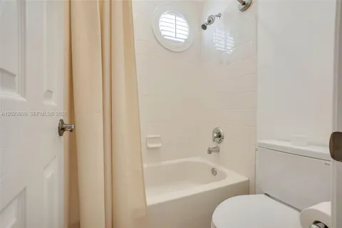 a bathroom with a toilet a sink and bathtub
