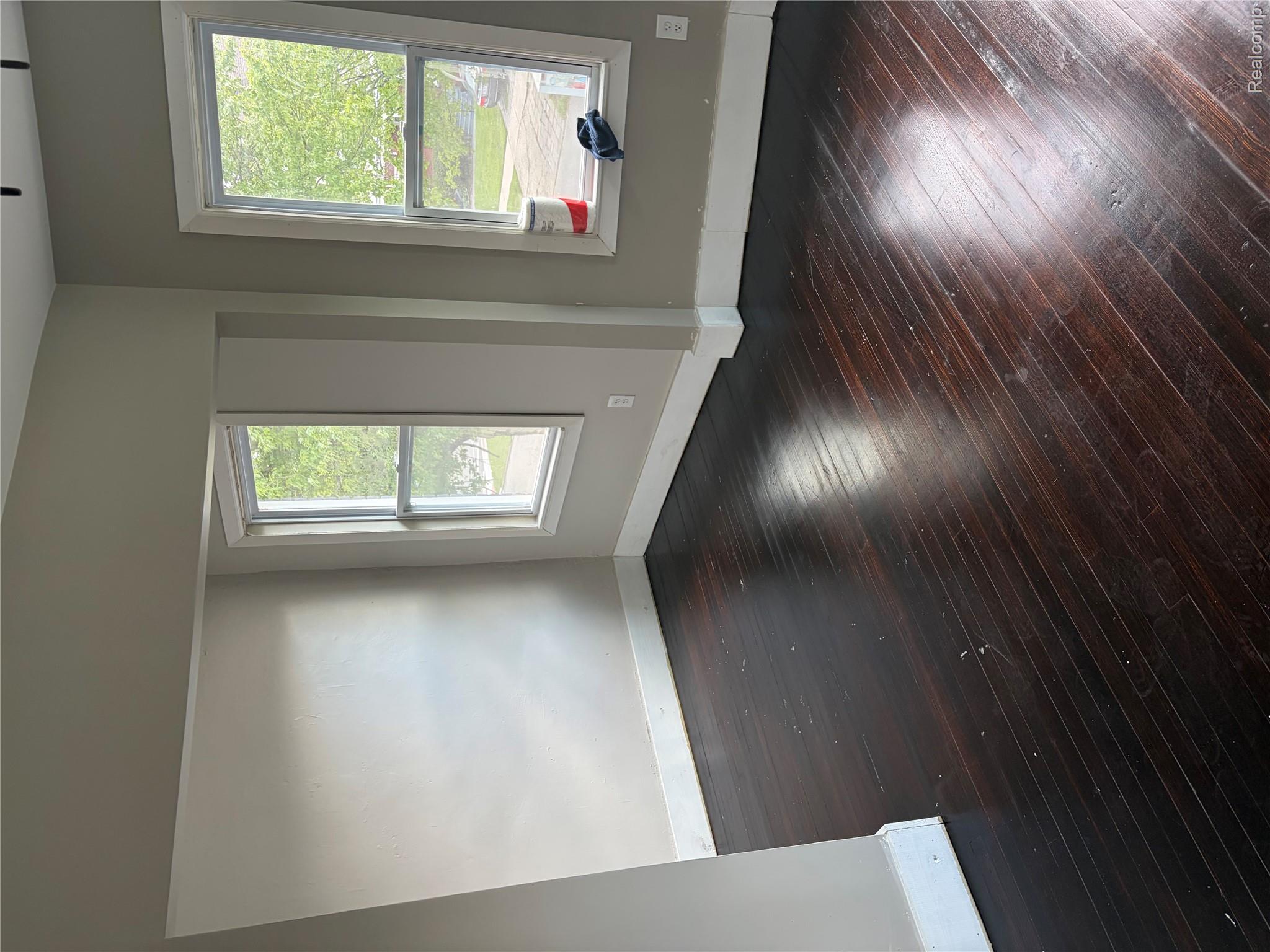 2420 Field Street Detroit, MI 48214 - Photo 12 of 15 Unfurnished room with dark wood-style floors and plenty of natural light