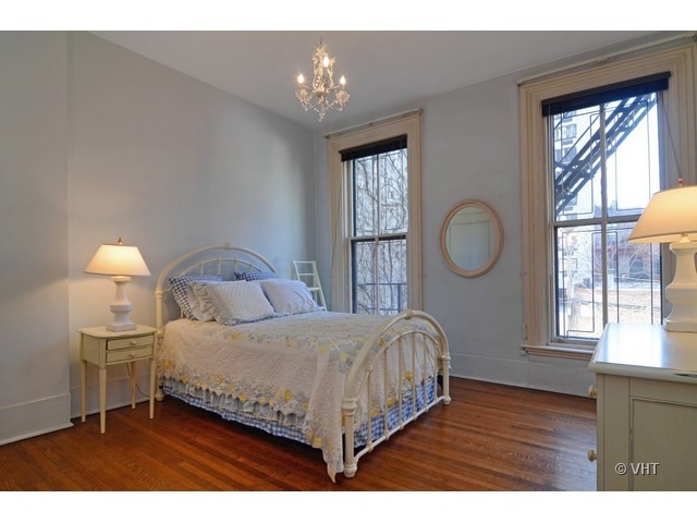 Undisclosed Address Chicago, IL 60610 - Photo 13 of 18 a bedroom with a bed mirror and window
