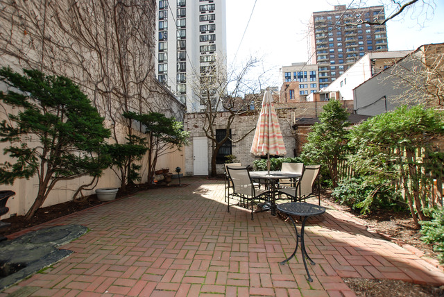 Undisclosed Address Chicago, IL 60610 - Photo 14 of 18 a view of a patio with table and chairs and potted plants