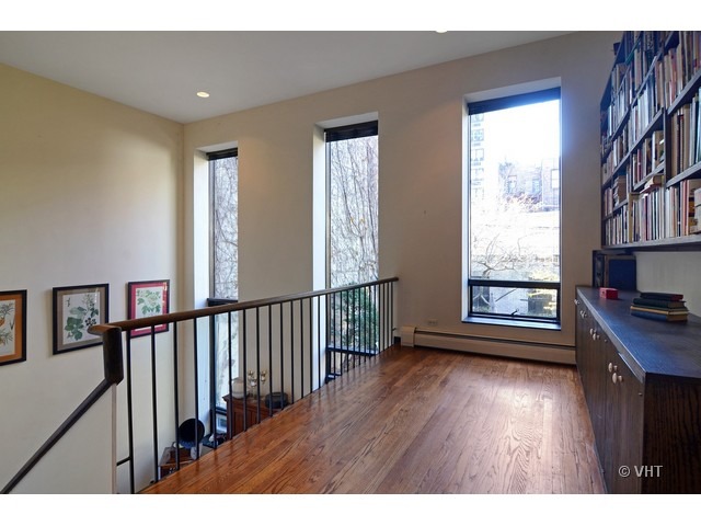 Undisclosed Address Chicago, IL 60610 - Photo 10 of 18 a view of hallway with windows and wooden floor