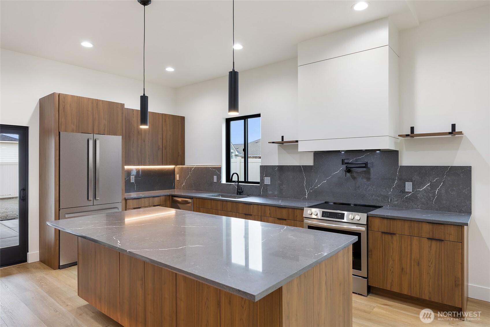 501 Sand Dune Road Moses Lake, WA 98837 - Photo 13 of 38 a kitchen with stainless steel appliances granite countertop a sink a stove and refrigerator