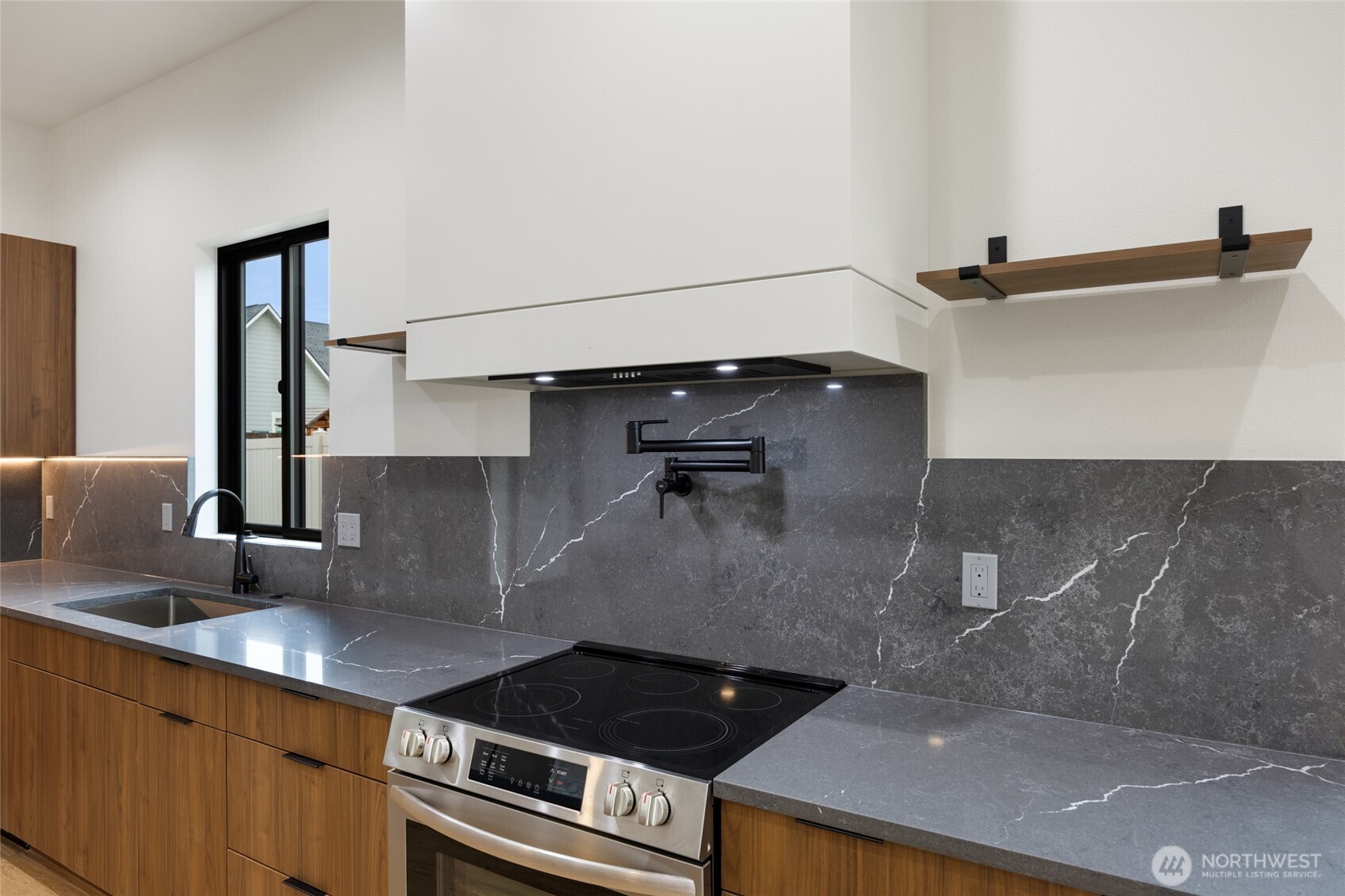 501 Sand Dune Road Moses Lake, WA 98837 - Photo 14 of 38 a kitchen with a sink and cabinets