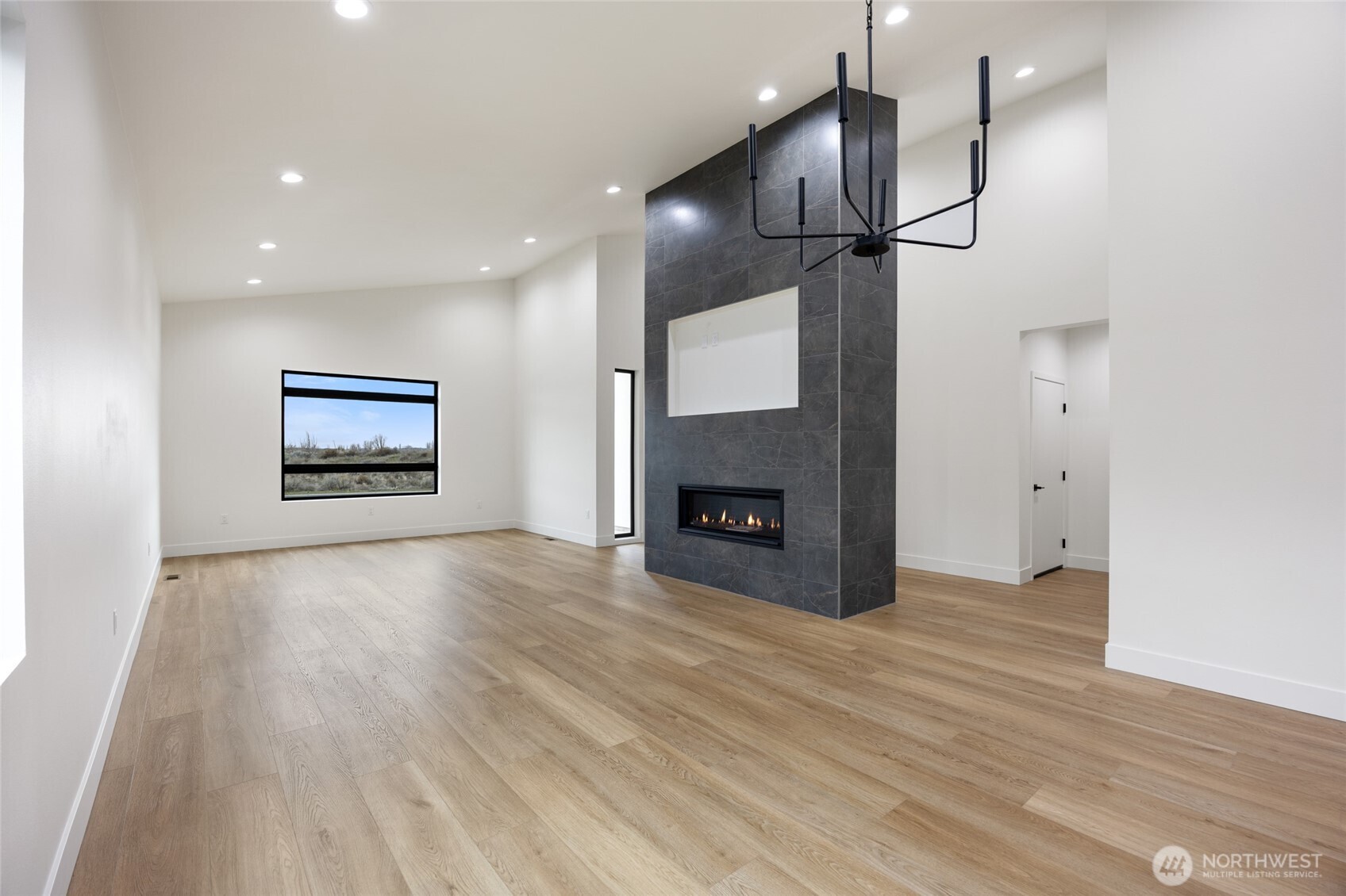 501 Sand Dune Road Moses Lake, WA 98837 - Photo 6 of 38 a view of empty room with wooden floor and fireplace