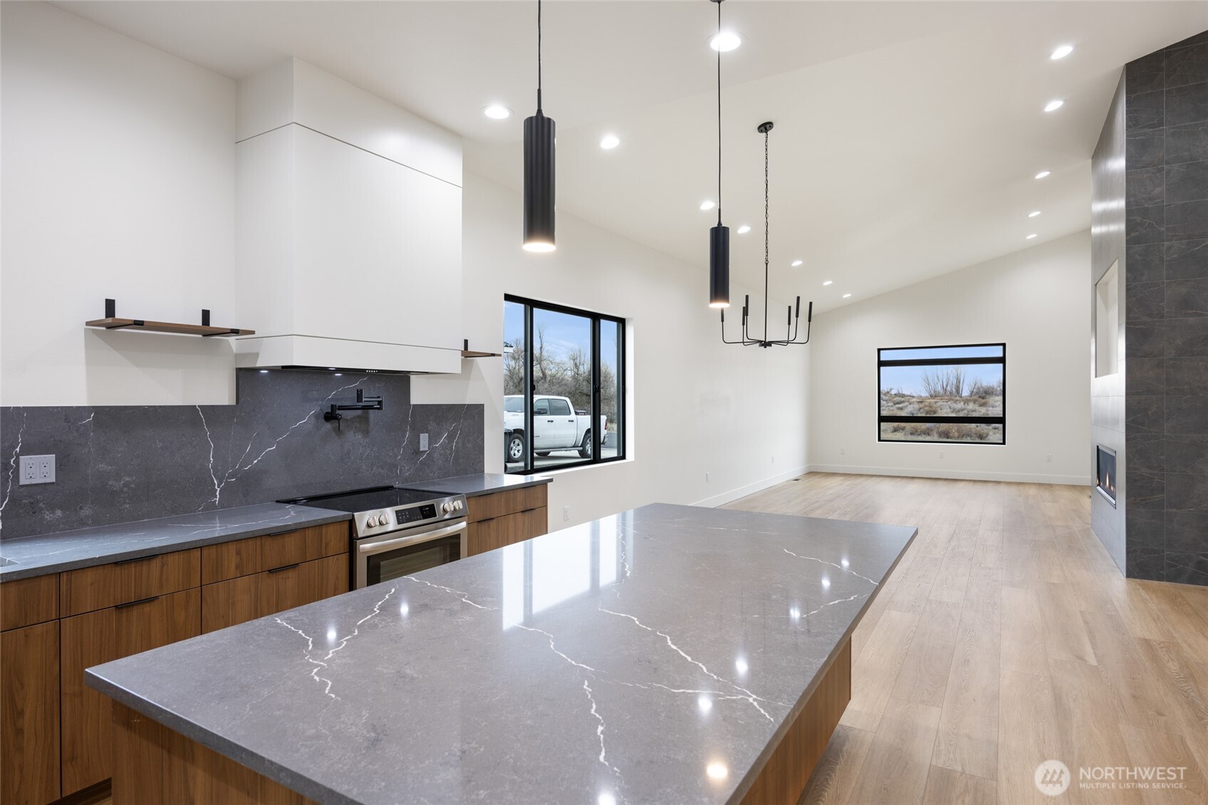 501 Sand Dune Road Moses Lake, WA 98837 - Photo 9 of 38 a kitchen with stainless steel appliances granite countertop a sink a stove and a wooden floors