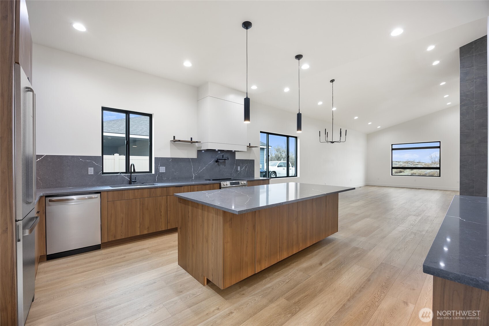 501 Sand Dune Road Moses Lake, WA 98837 - Photo 10 of 38 a kitchen with stainless steel appliances granite countertop a sink a stove and a wooden floor