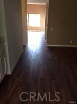 a view of an empty room and wooden floor
