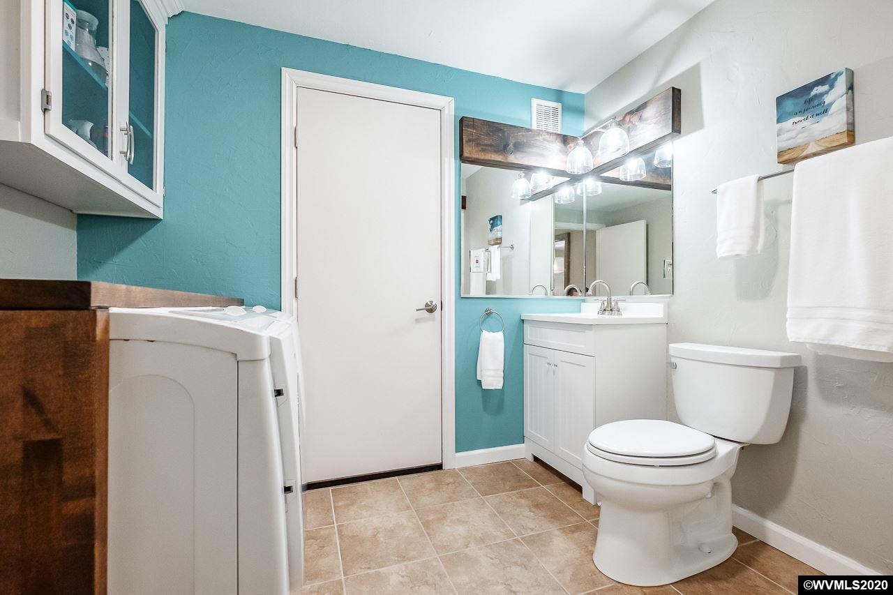 4890 Liberty Road Dallas, OR 97338 - Photo 13 of 42 a bathroom with a toilet sink and a mirror