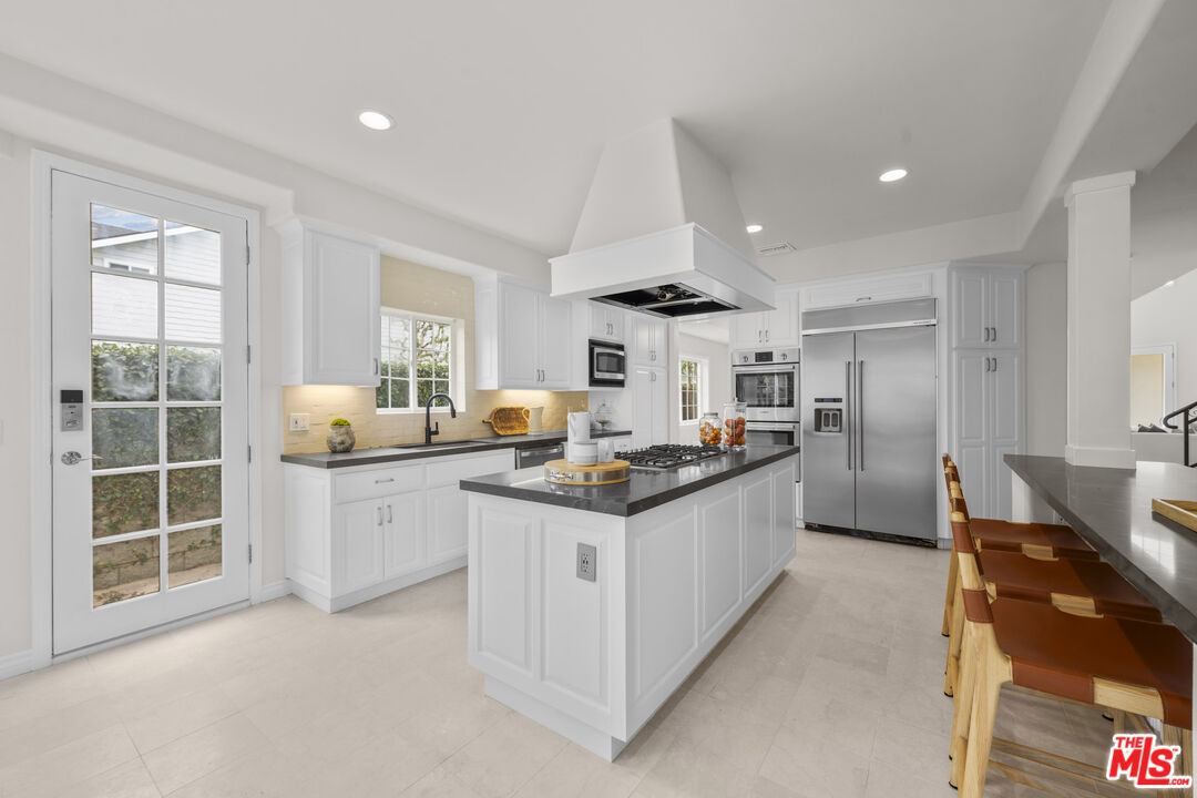 7861 West 80th Street Playa del Rey, CA 90293 - Photo 12 of 42 a large kitchen with stainless steel appliances granite countertop a stove and a sink