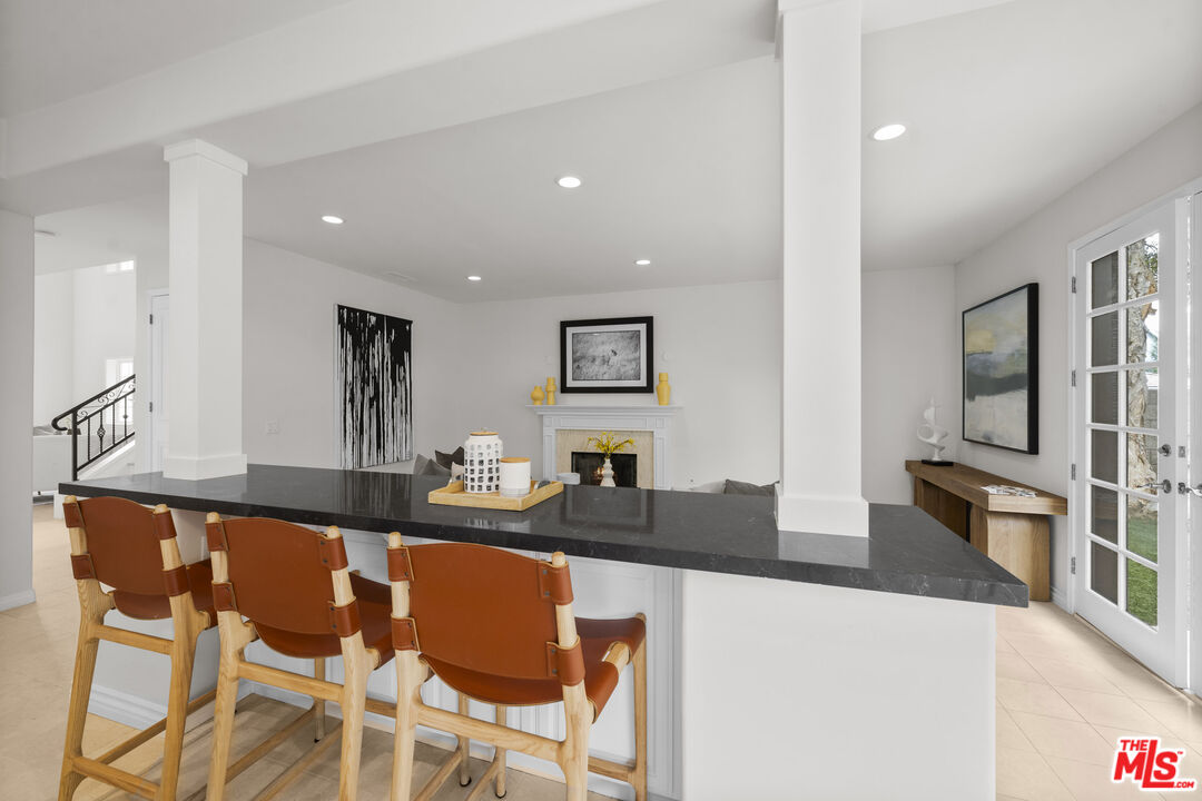 7861 West 80th Street Playa del Rey, CA 90293 - Photo 14 of 42 a kitchen with granite countertop a sink and chairs