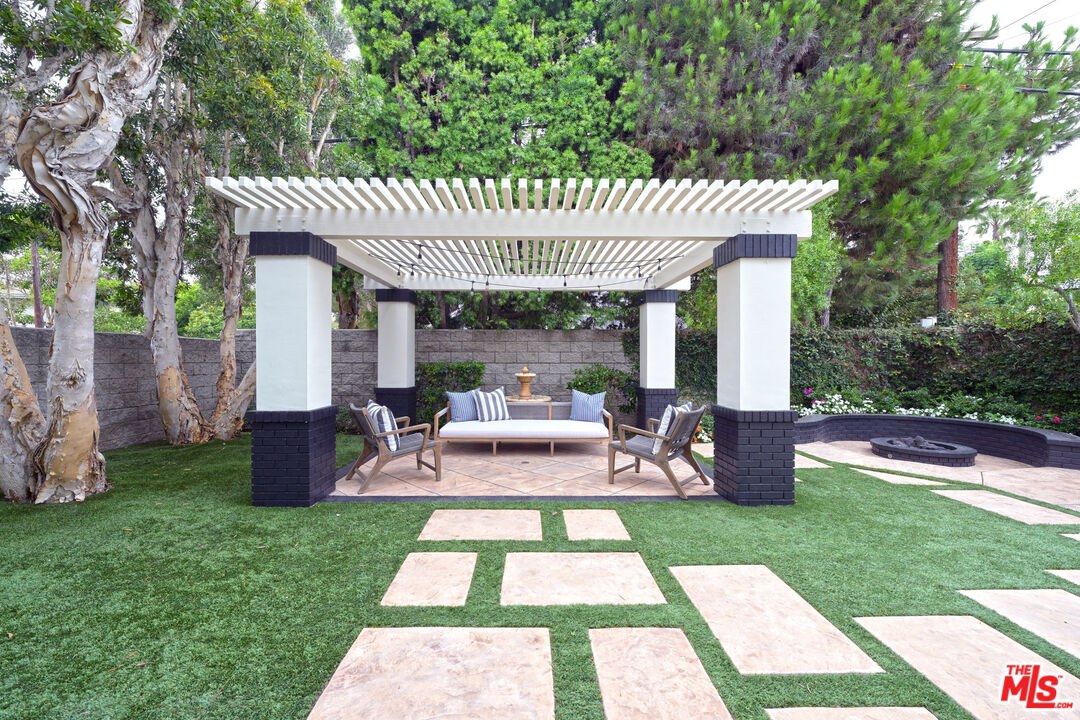 7861 West 80th Street Playa del Rey, CA 90293 - Photo 19 of 42 a view of a patio with table and chairs potted plants and large tree