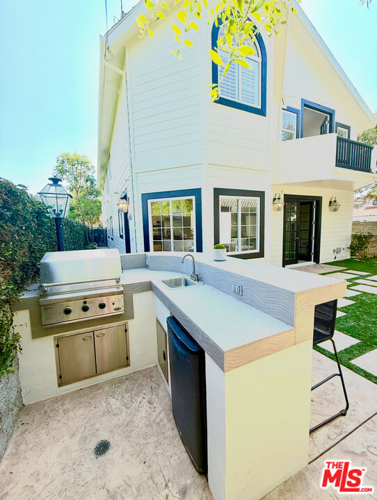 7861 West 80th Street Playa del Rey, CA 90293 - Photo 22 of 42 a kitchen with stainless steel appliances granite countertop a sink and cabinets