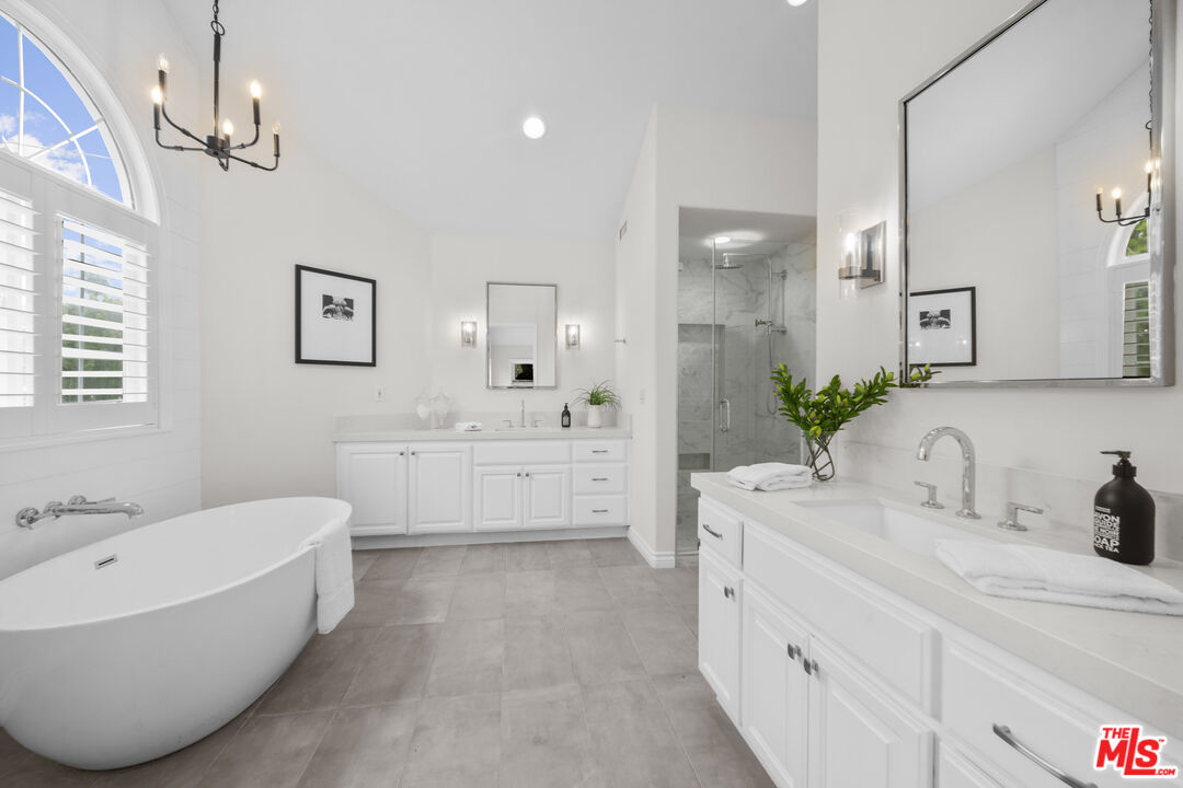 7861 West 80th Street Playa del Rey, CA 90293 - Photo 28 of 42 a bathroom with a double vanity sink a mirror a bathtub and window