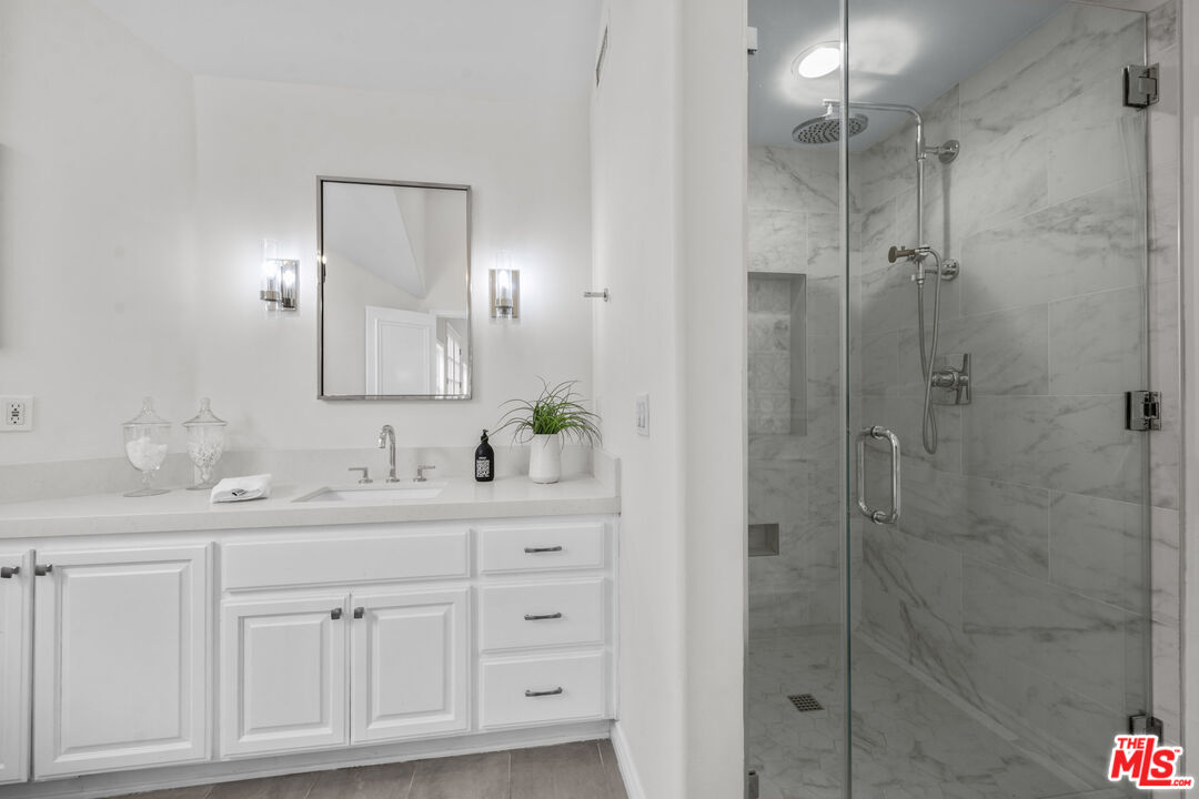 7861 West 80th Street Playa del Rey, CA 90293 - Photo 30 of 42 a bathroom with a shower sink and mirror