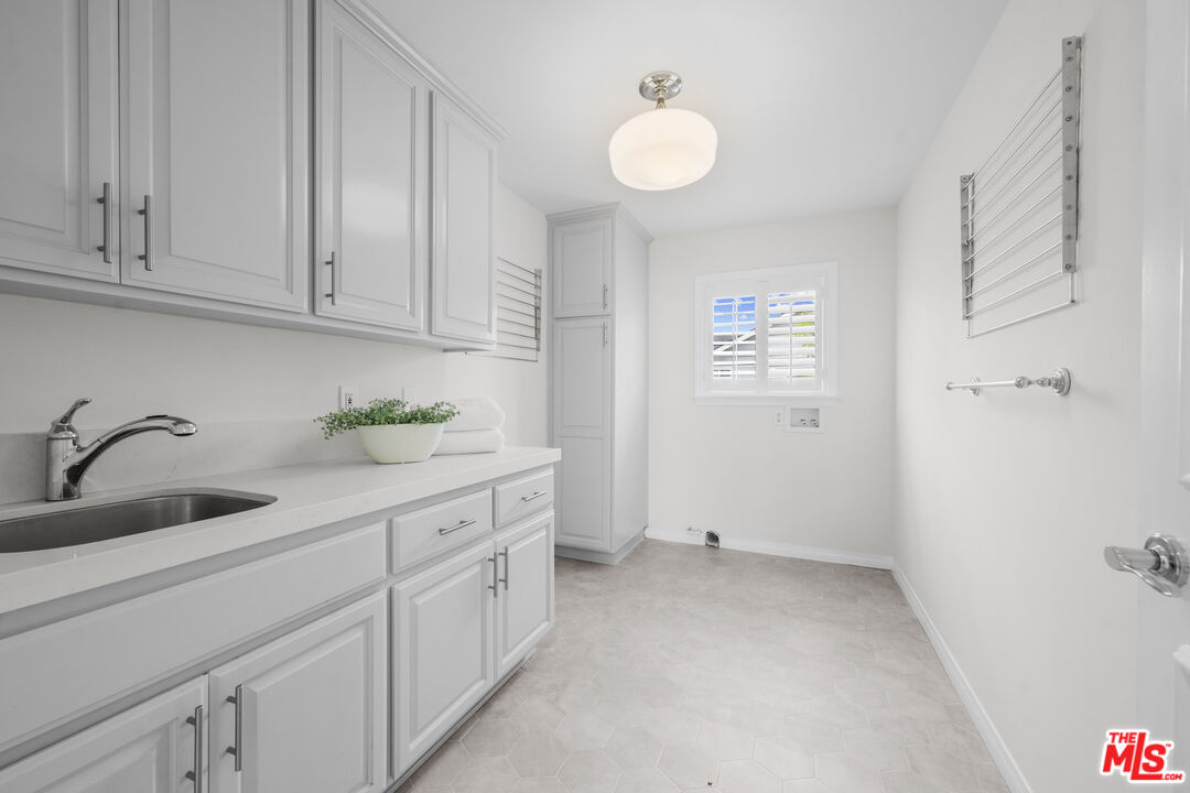 7861 West 80th Street Playa del Rey, CA 90293 - Photo 34 of 42 a kitchen with white cabinets and sink