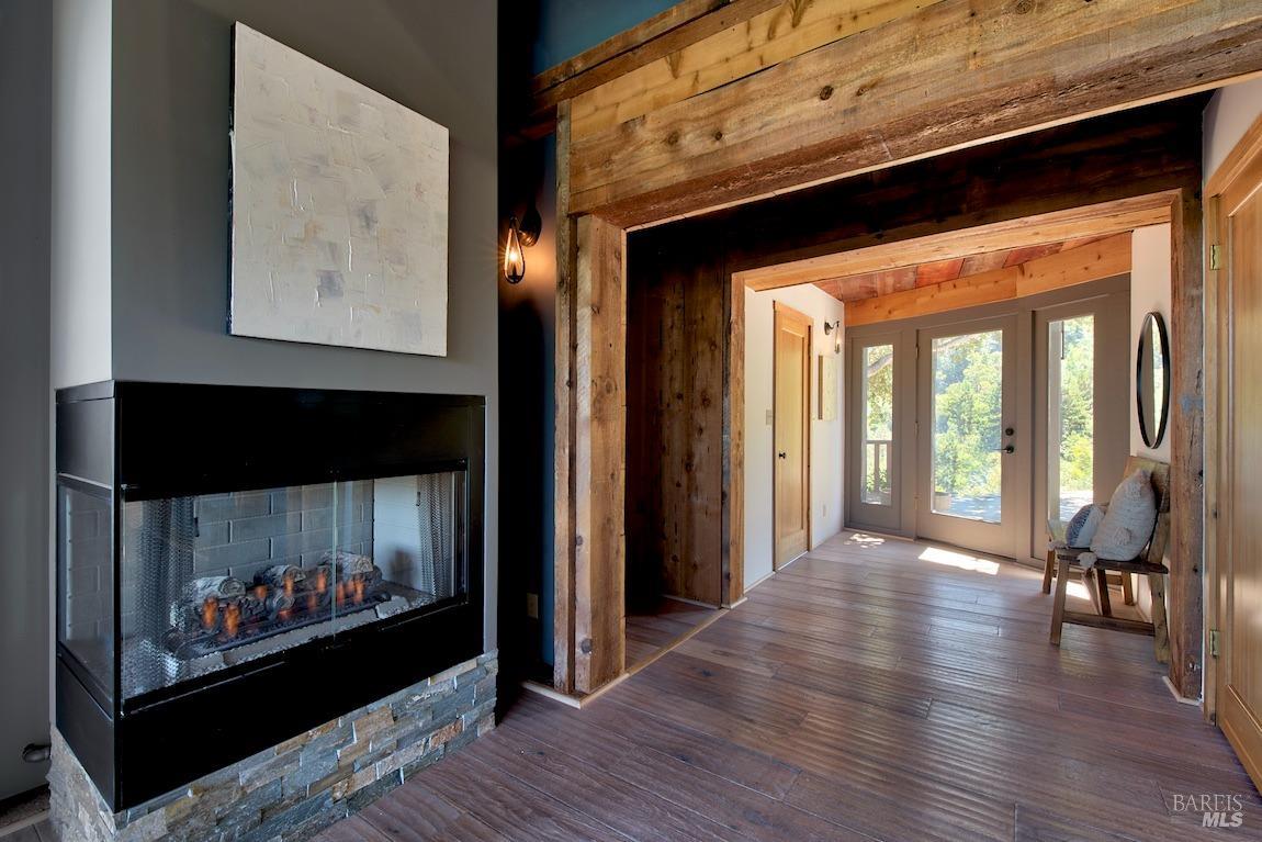600 Murray Avenue Kentfield, CA 94904 - Photo 11 of 59 a view of a hallway with wooden floor and a fireplace