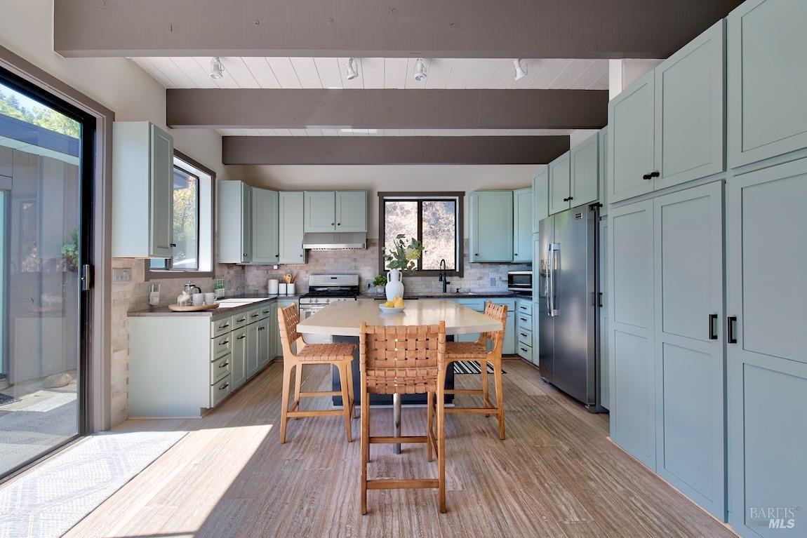 600 Murray Avenue Kentfield, CA 94904 - Photo 18 of 59 a kitchen with a dining table chairs refrigerator and cabinets