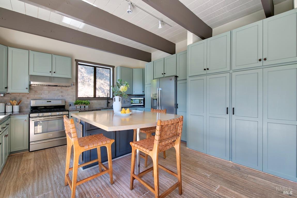 600 Murray Avenue Kentfield, CA 94904 - Photo 19 of 59 a kitchen with stainless steel appliances granite countertop a refrigerator a stove a sink dishwasher and white cabinets with wooden floor