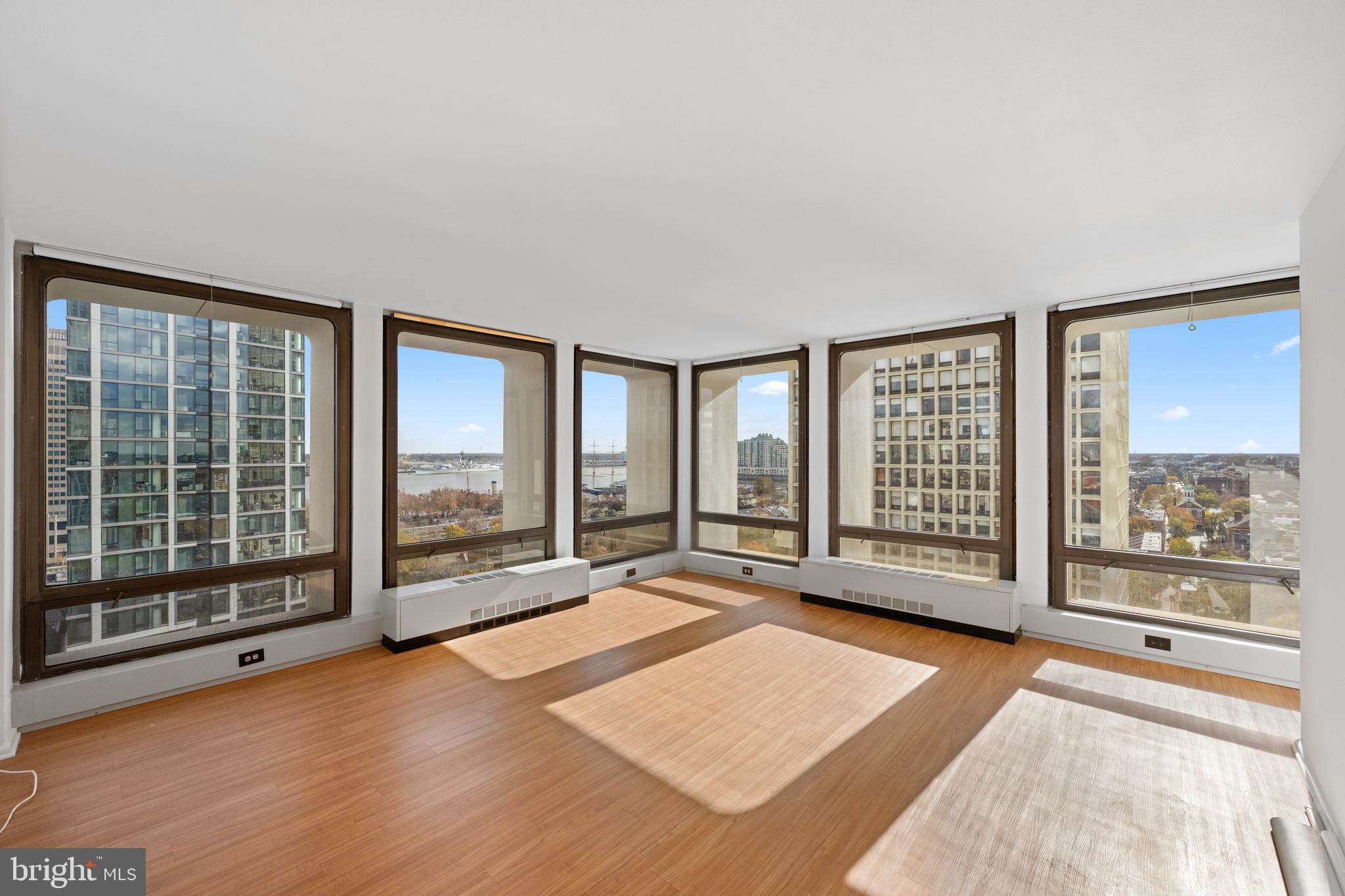 200 Locust Street, Unit 10GN Philadelphia, PA 19106 - Photo 1 of 28 an empty room with floor to ceiling windows and windows