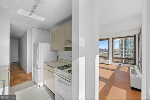a kitchen with stainless steel appliances granite countertop a refrigerator and a stove