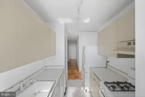 a kitchen with a refrigerator and a stove