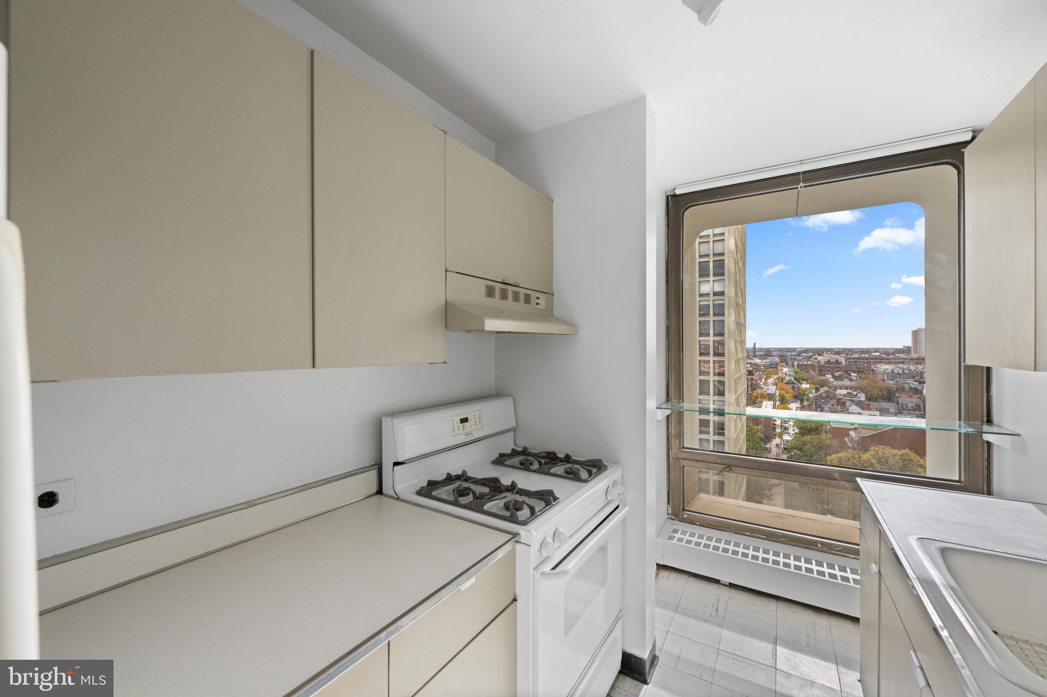 200 Locust Street, Unit 10GN Philadelphia, PA 19106 - Photo 13 of 28 a kitchen with a stove and a view of living room