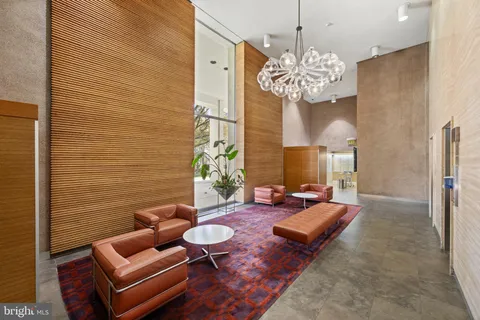 a living room with patio furniture and a chandelier