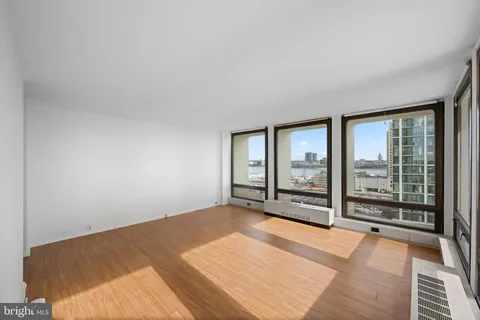 an empty room with floor to ceiling windows