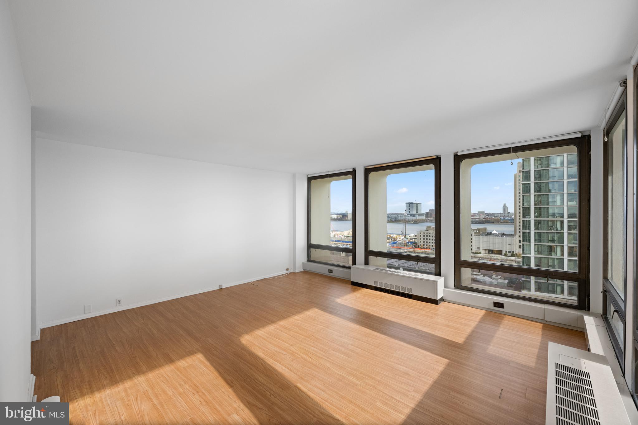 200 Locust Street, Unit 10GN Philadelphia, PA 19106 - Photo 8 of 28 an empty room with floor to ceiling windows