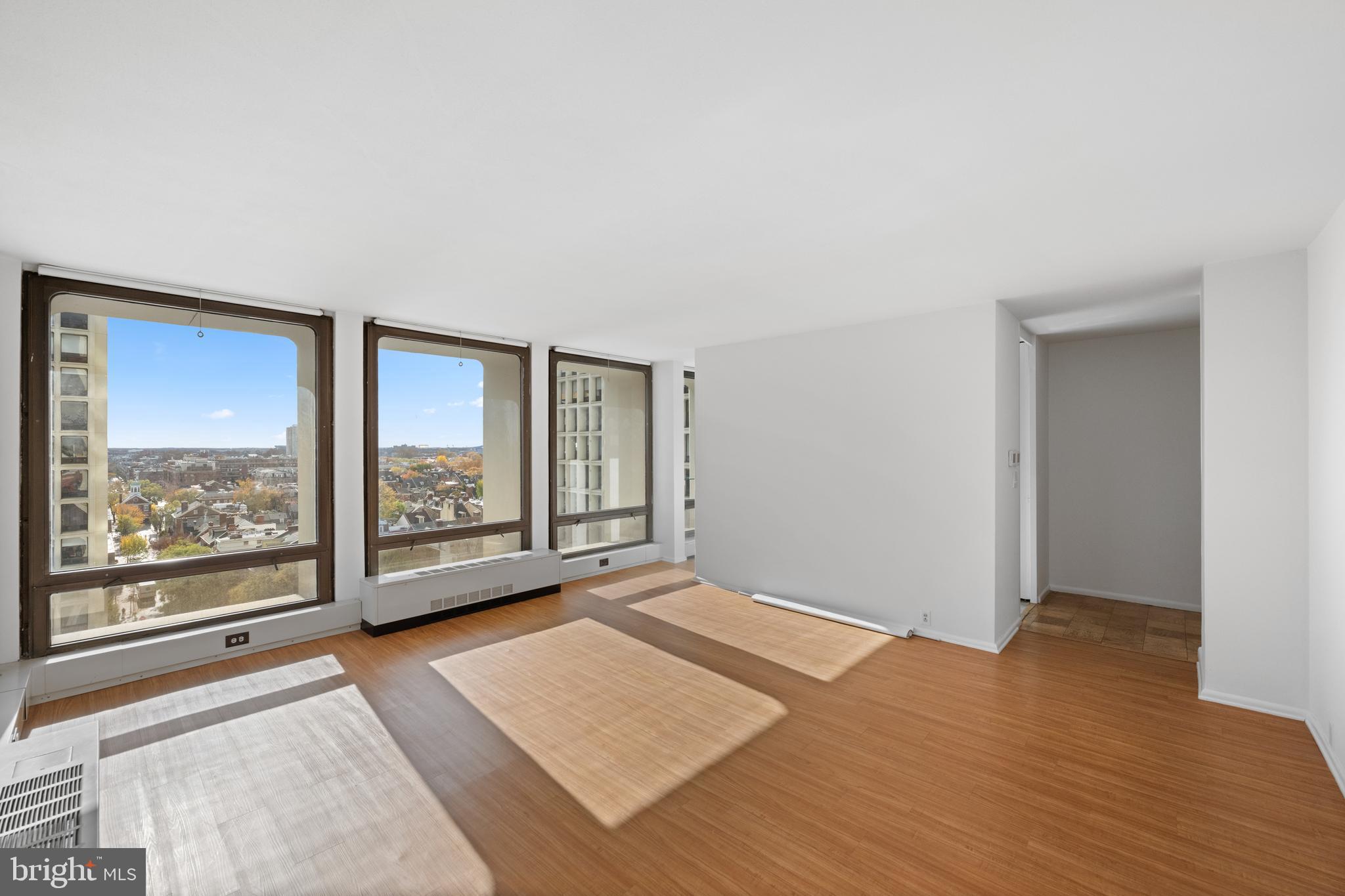 200 Locust Street, Unit 10GN Philadelphia, PA 19106 - Photo 9 of 28 an empty room with wooden floor and windows