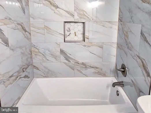 a close view of staircase with washer and dryer