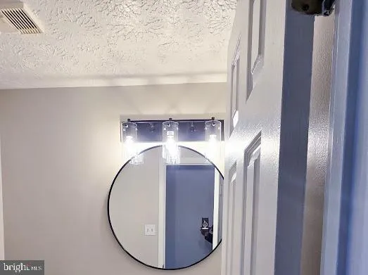 a kitchen with granite countertop white cabinets and stainless steel appliances