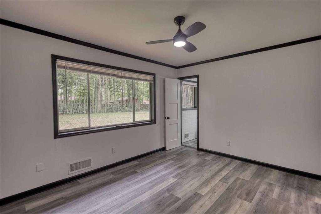 555 Joy Street Jackson, GA 30233 - Photo 41 of 56 a view of empty room with wooden floor and fan