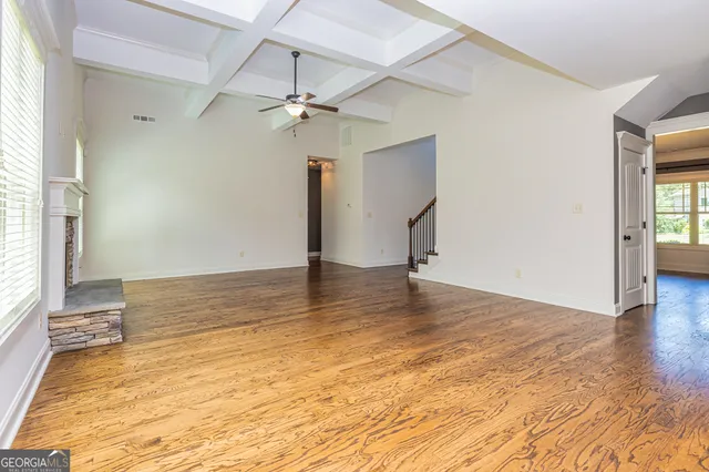 a view of a room with wooden floor and window