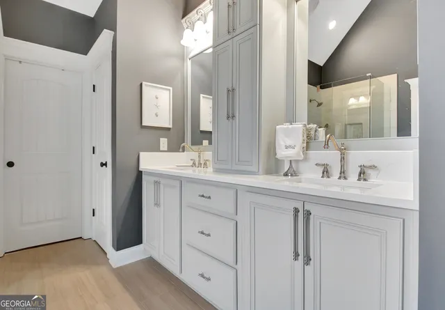a spacious bathroom with double sink and a mirror