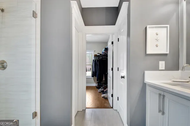 a view of walk in closet with clothes and shoes