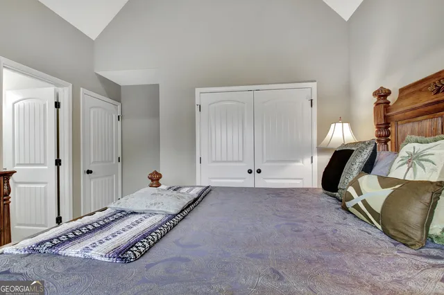 a bedroom with a bed and a view of bathroom