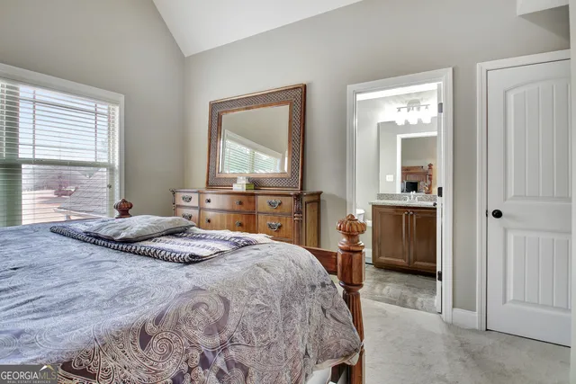 a bathroom with a granite countertop toilet and a sink